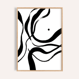 Framed black and white art with abstract black brush strokes on a white background in a light wood frame