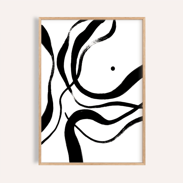 Framed black and white art with abstract black brush strokes on a white background in a light wood frame