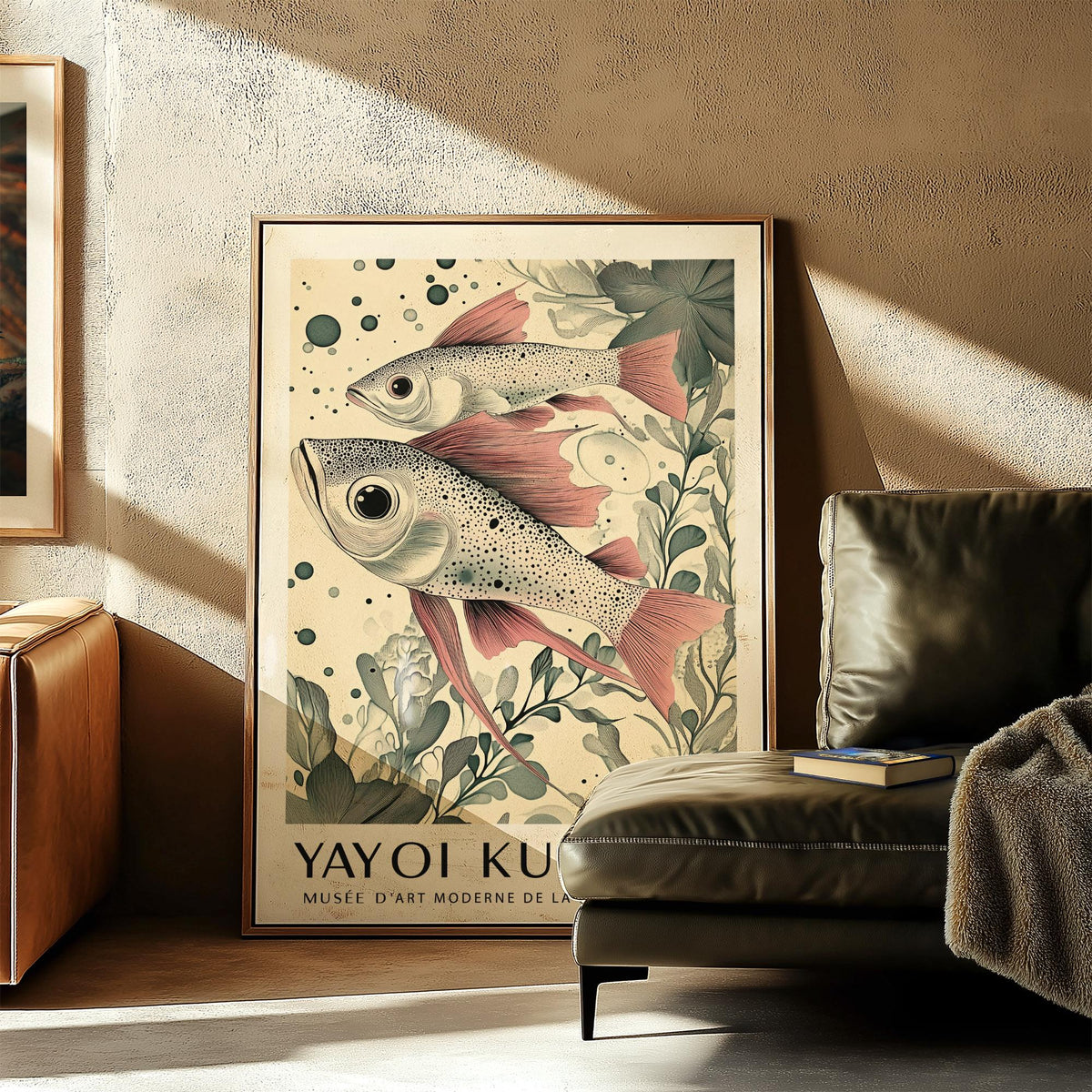 Large Fish wall art leaning against textured wall with sofa and book in living room