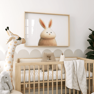 Print of a fluffy rabbit illustration in soft brown and cream above a wooden cot with a giraffe soft toy