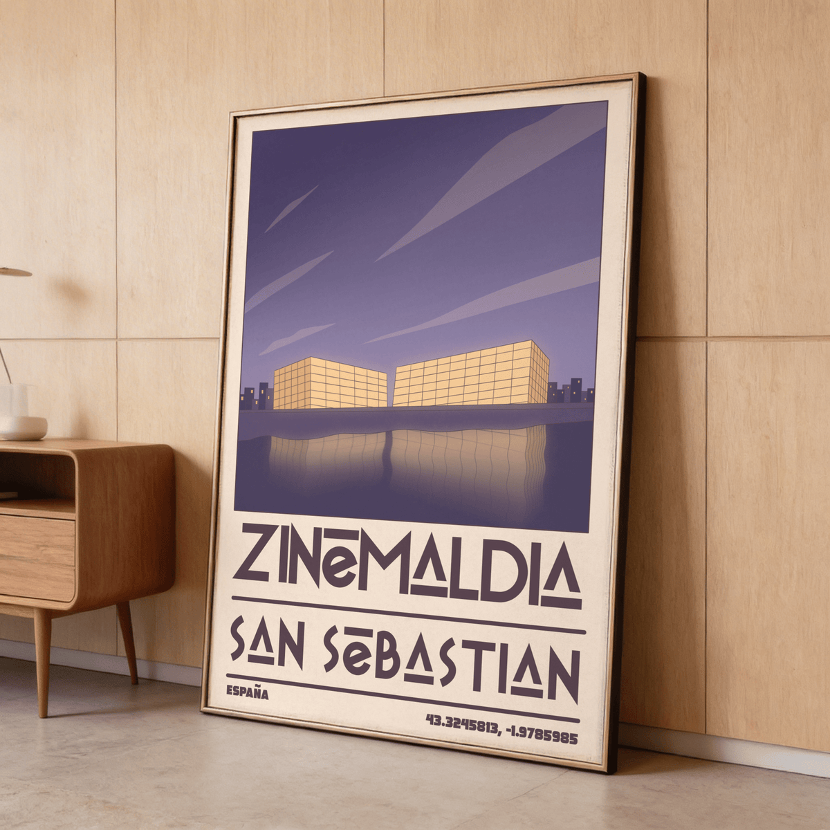 Framed San Sebastian wall art of minimalist yellow buildings with purple sky leaning on a wooden floor