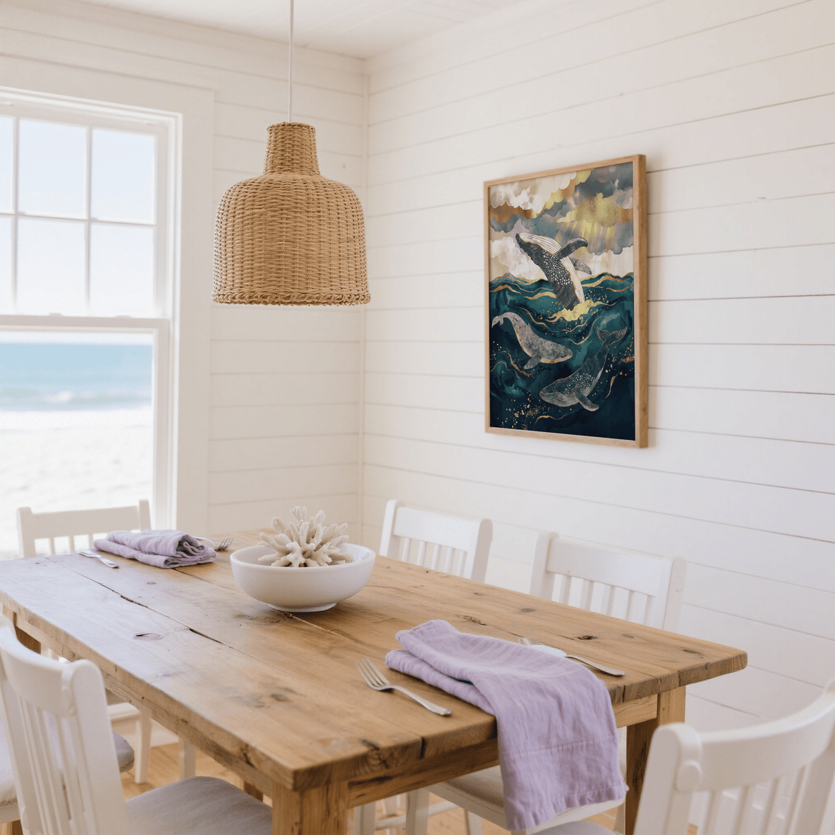 Ocean art print of a whale illustration with blue and gold hues in a white dining room with wooden table