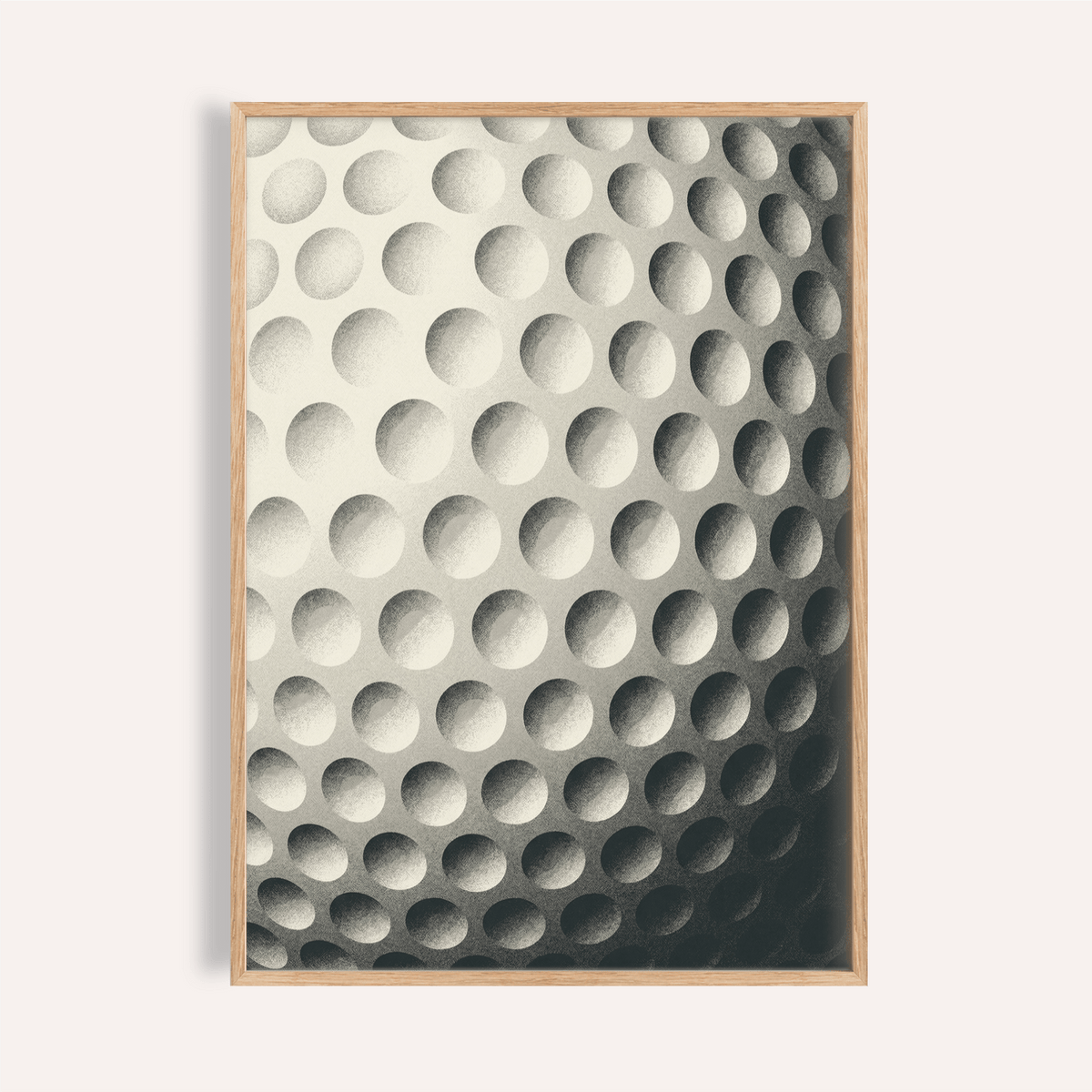 Framed close-up of textured golf ball art print in minimalist black and white style
