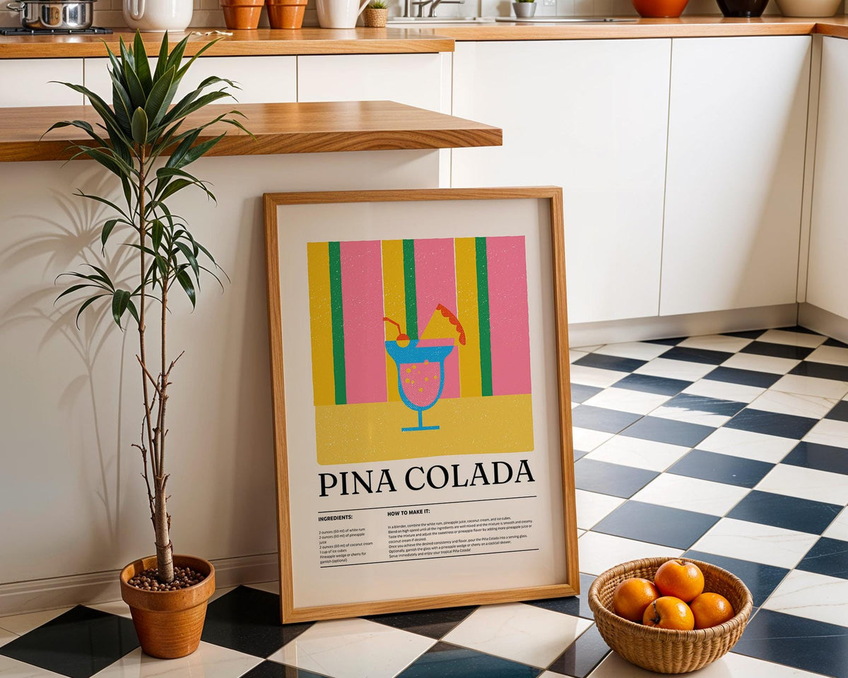 Wall art for Kitchen leaning against a white cupboard with a black and white tiled floor and a plant nearby