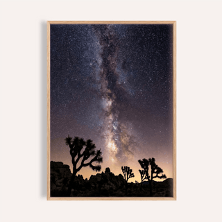 Framed Night Desert Poster showing the Milky Way over desert trees in dark blue and black tones