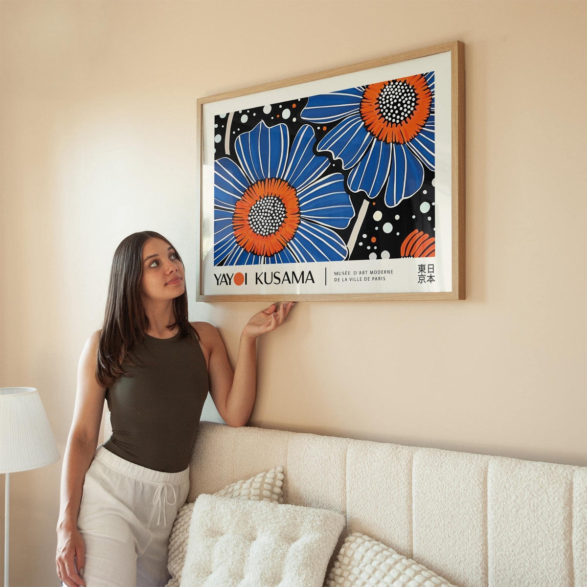 Unique Flower Art blue flower illustration in pop-art style hanging above cream sofa with lamp nearby