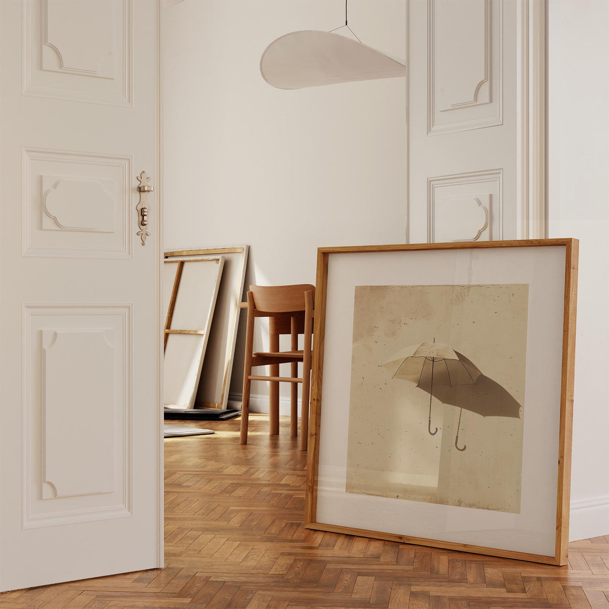 Surrealism Prints leaning on wooden parquet floor with chair in bright room