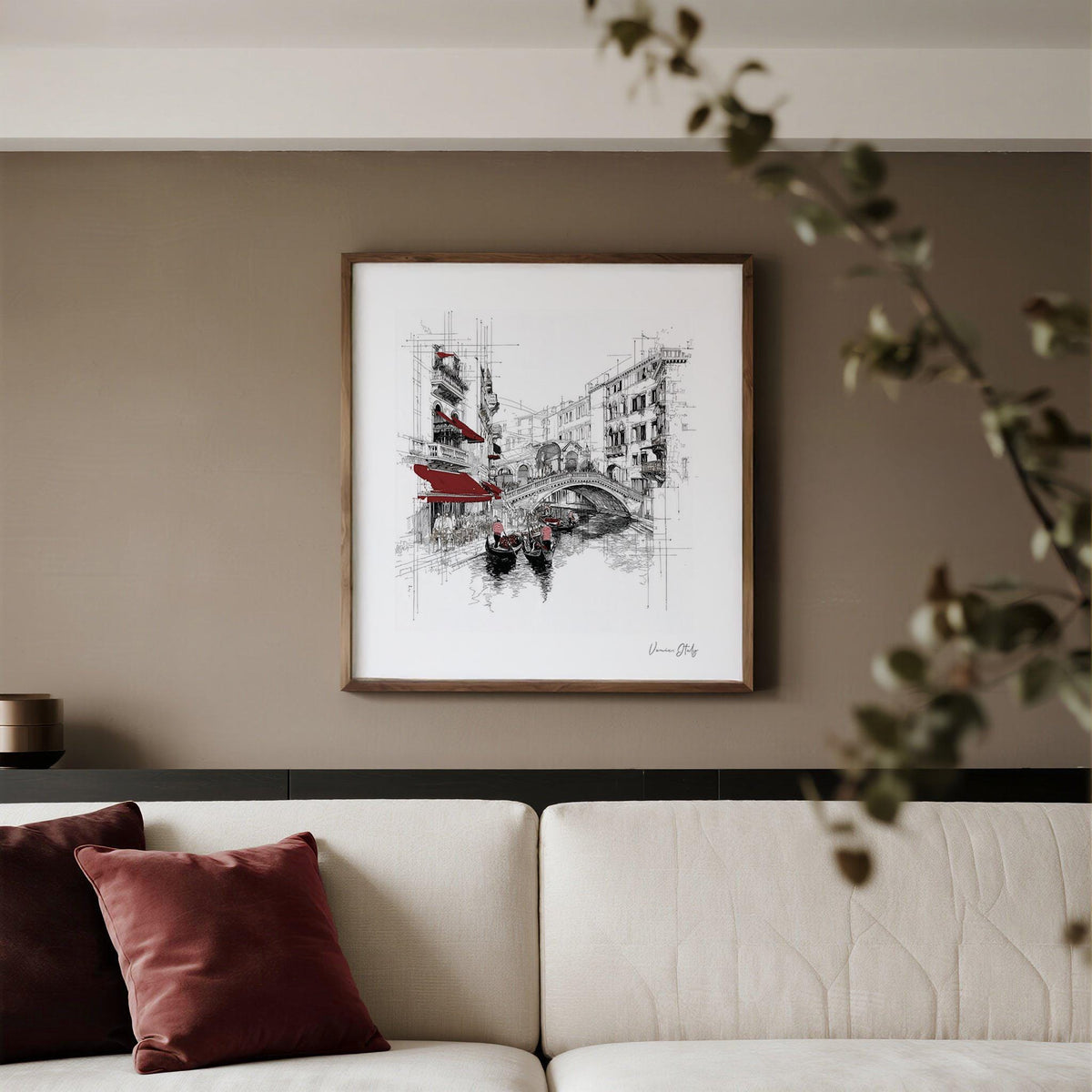 Wall Art of Venice Italy in a living room with beige walls and a sofa with red cushions