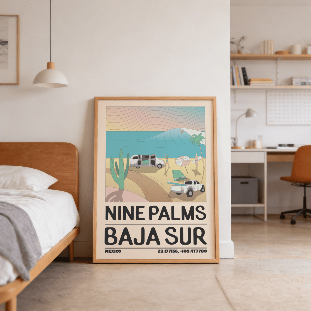 Baja Sur wall art print leaning on a wooden floor near a bed in a bedroom with shelving