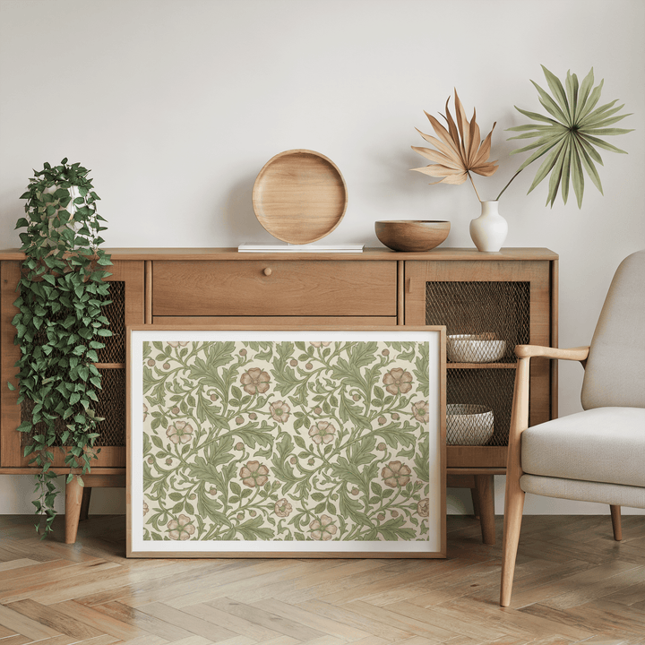 Botanical wall decor print with vintage floral pattern leaning on wood sideboard with plant