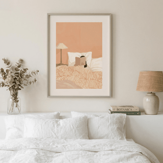 Woman Reading Book Art print of a person reading in bed with warm beige and brown tones in a bedroom