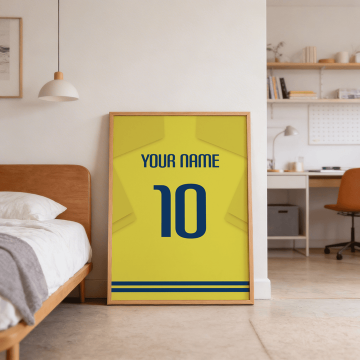 Print leaning on floor showing football shirt poster in yellow with blue number beside a bed in a bedroom
