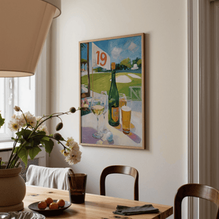 Watering Hole Golf Art Print hung above dining table with flowers and bowls in soft light