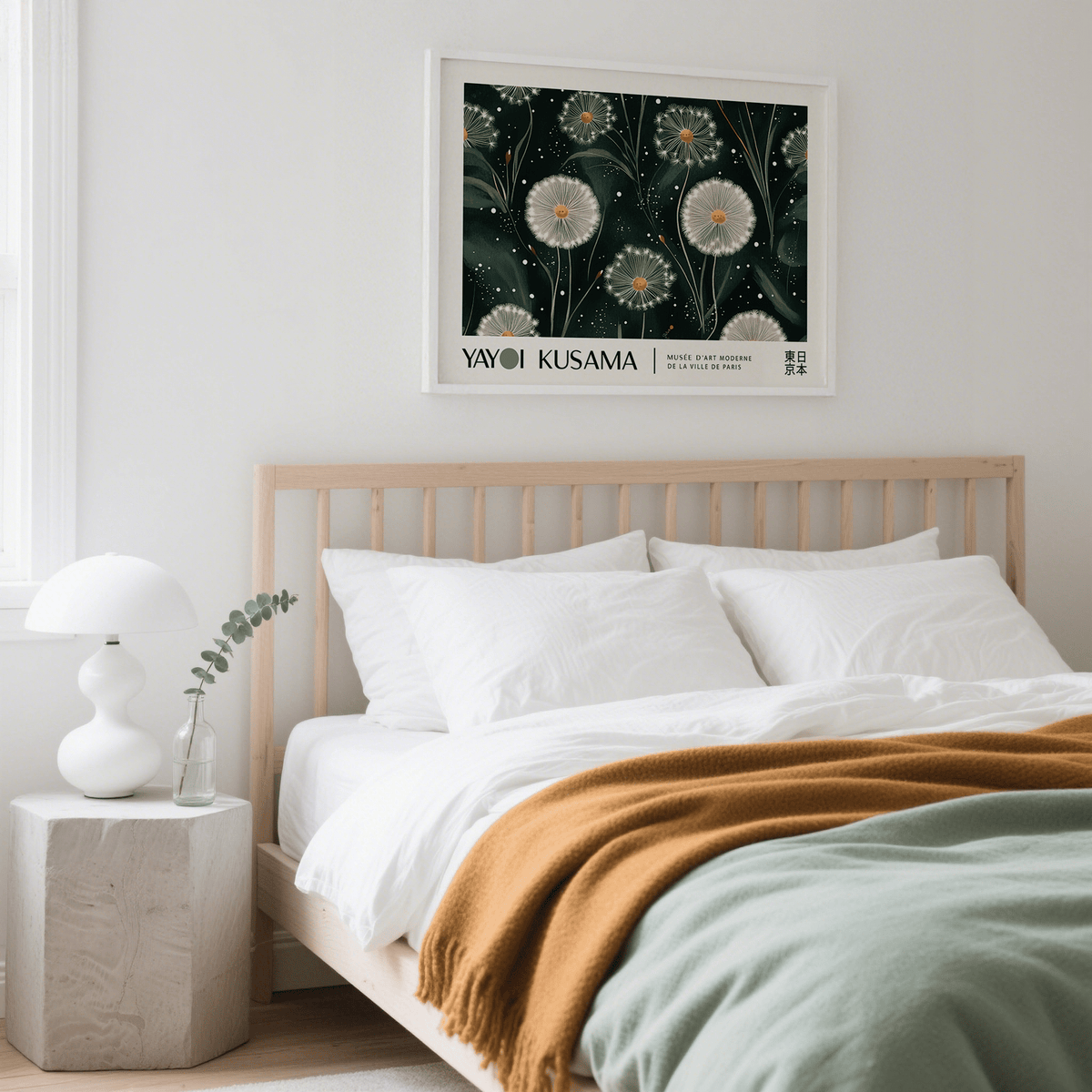 Emerald Green wall art of dandelion seed heads in a white frame above a wooden bed with white bedding and a brown throw