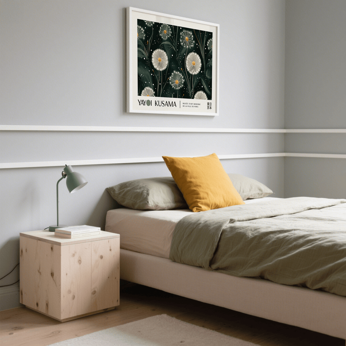 Print on a wall in a bedroom of dandelion seed heads illustration with emerald green and white tones above a bed with cushions