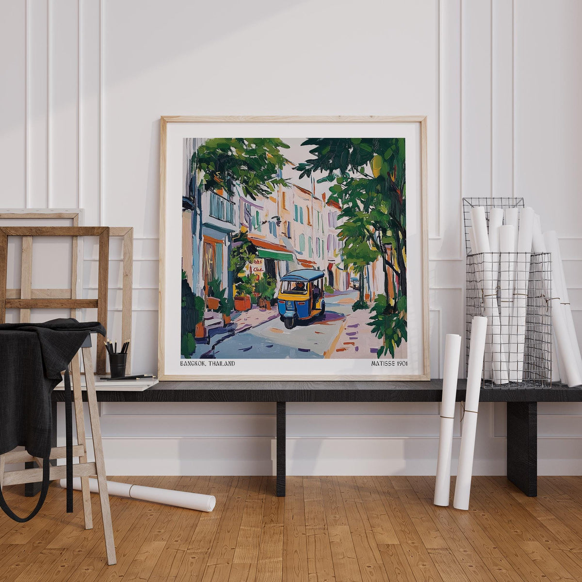 Holiday Prints showing a colourful tuk-tuk in a street with green trees leaning on a black bench