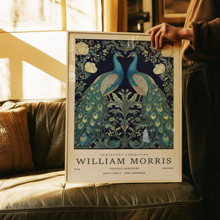 Large Peacock Wall Art showing a pair of blue and green peacocks with floral details held above a brown leather sofa
