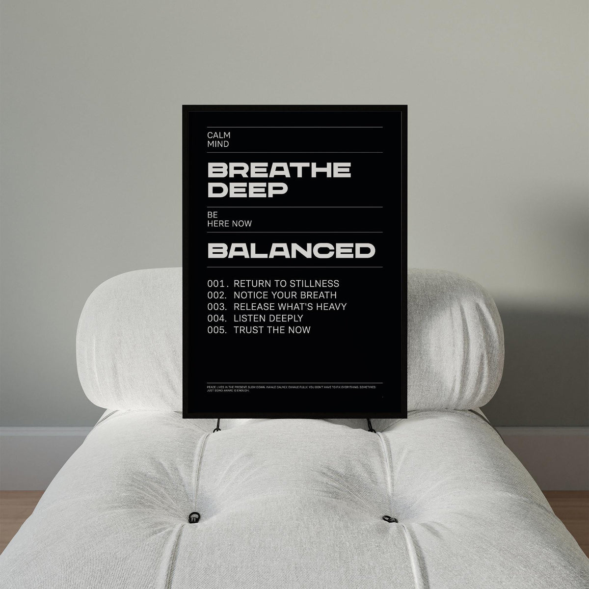 Framed Phrases for Wall Art with black and white minimalist typography on a white chair