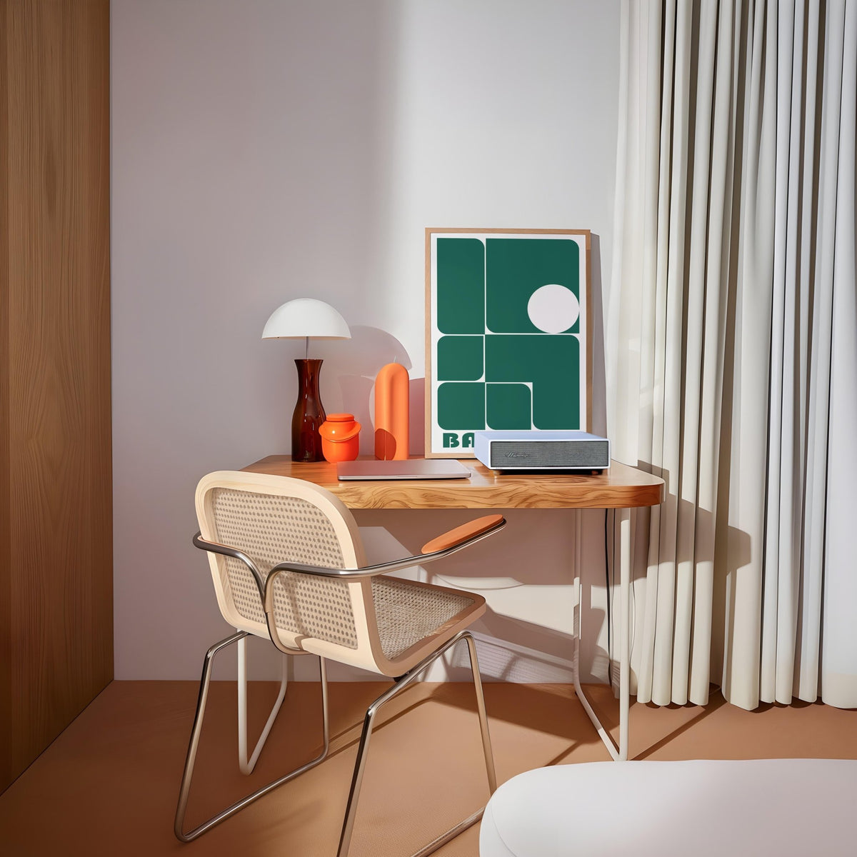 Art for Office print leaning on a desk with green geometric shapes and bauhaus text and a lamp nearby