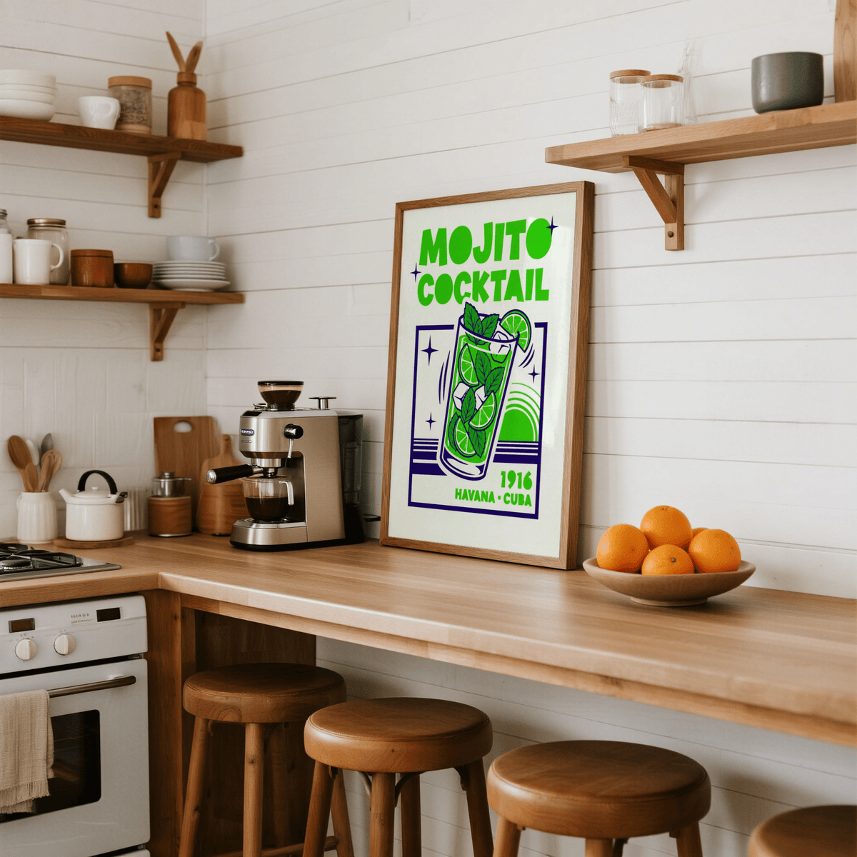Mojito Cocktail Print leaning on a wooden kitchen counter with bar stools and a bowl of oranges