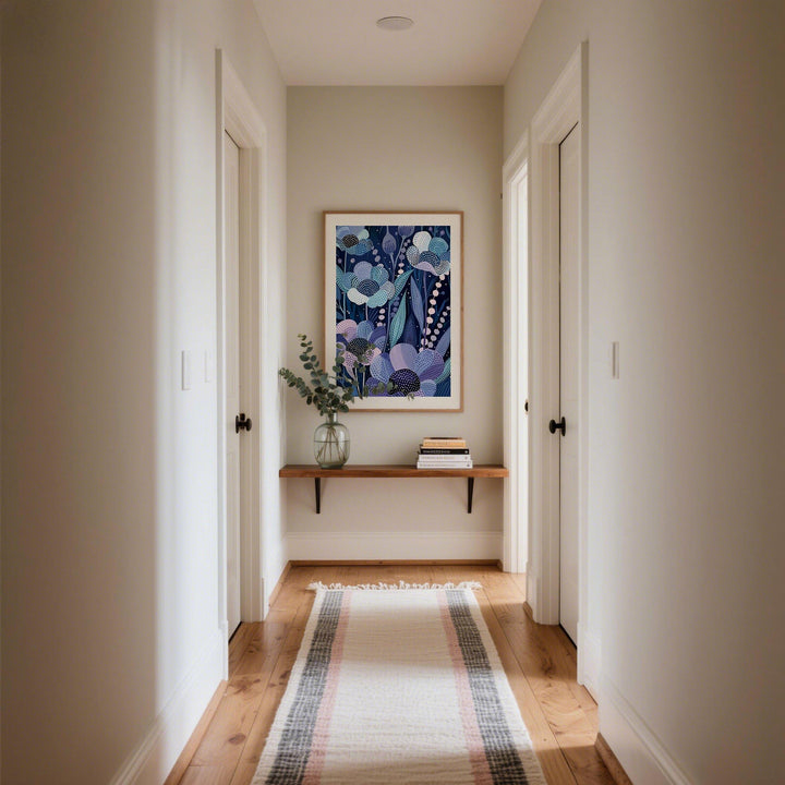 Modern Flower Art print with indigo floral pattern hanging in a hallway above a wooden shelf with a glass vase