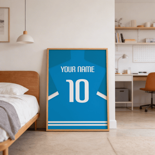 Print leaning on floor of bright blue minimalist football shirt poster with white number 10 beside a wooden bed