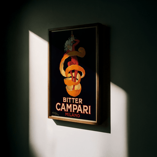 Vintage Bitter Aperitif Poster framed close-up of a woman with orange peel and aperitif bottle in dark setting