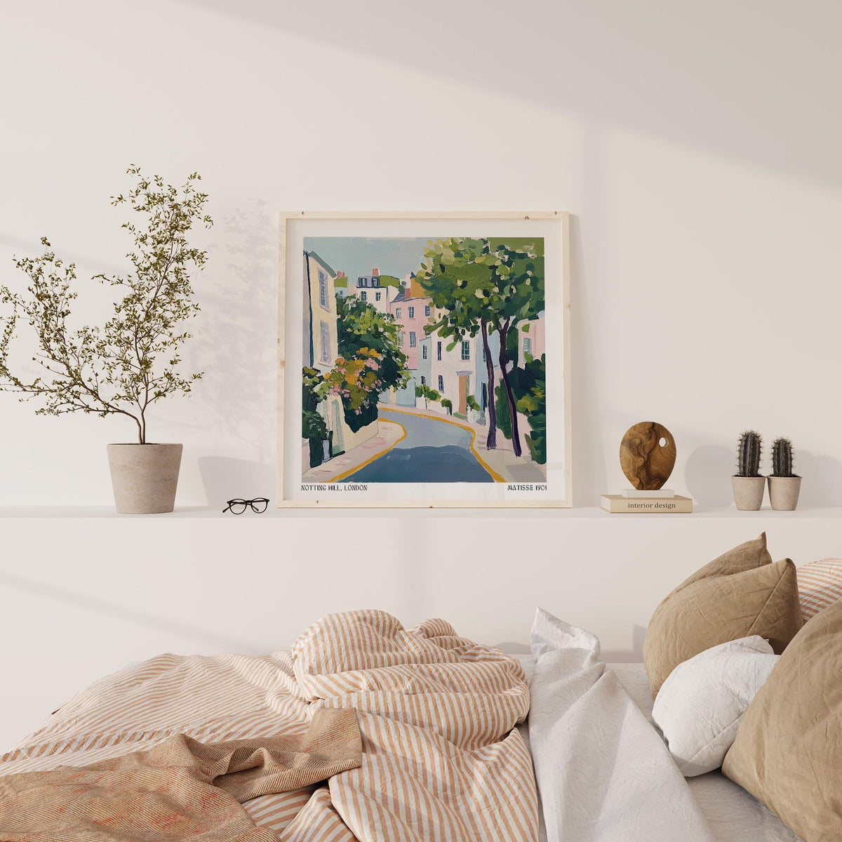 Notting Hill Poster print leaning on a shelf with neutral decor and brown bed cushions