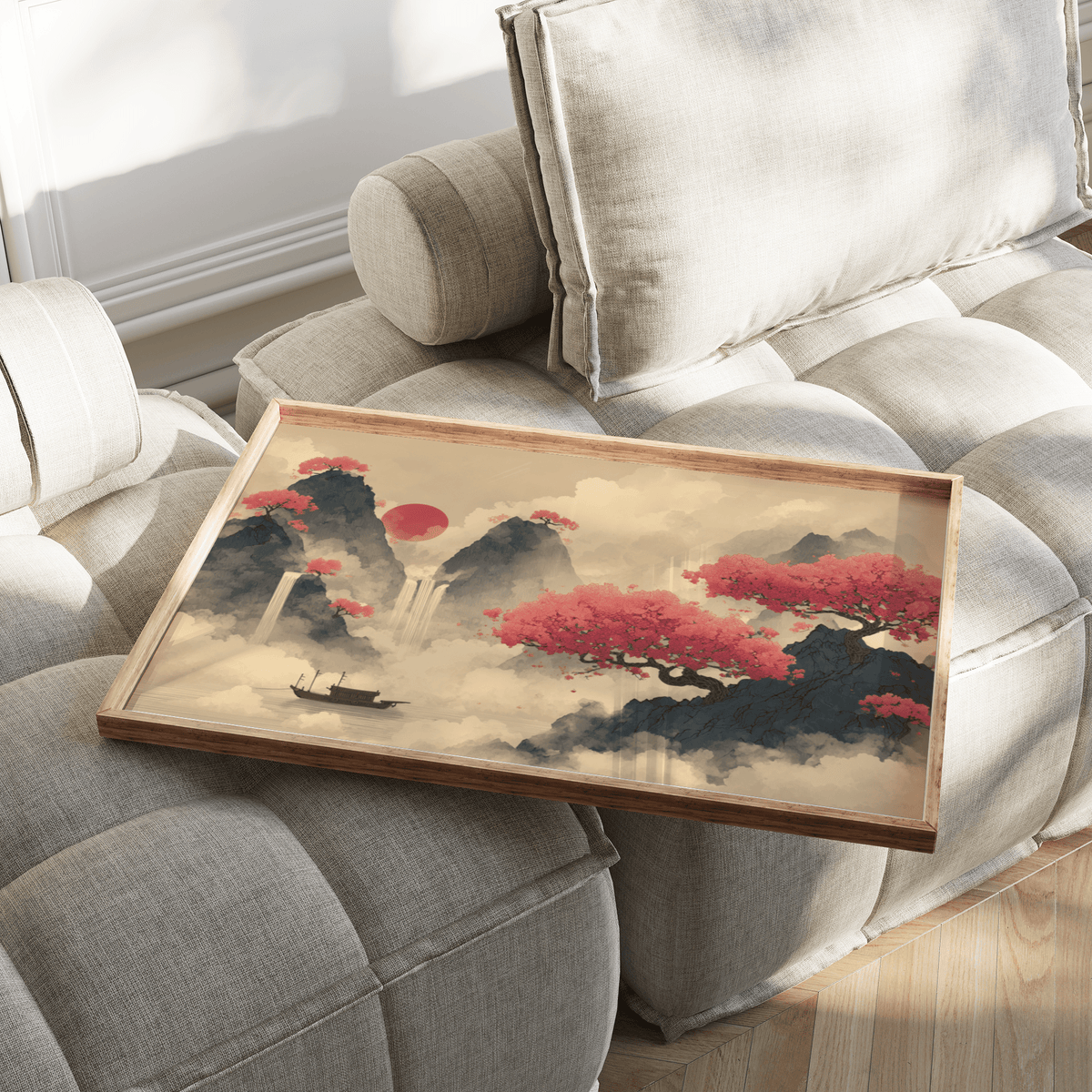 Ink landscape poster of red cherry blossom trees on a wooden tray on a cream sofa