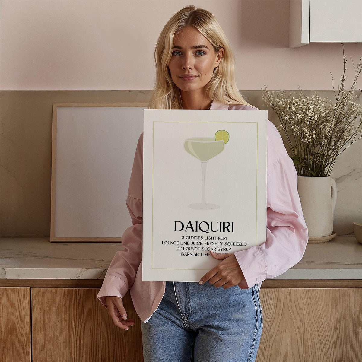 Person holding daiquiri cocktail recipe print with minimalist style and lime green details
