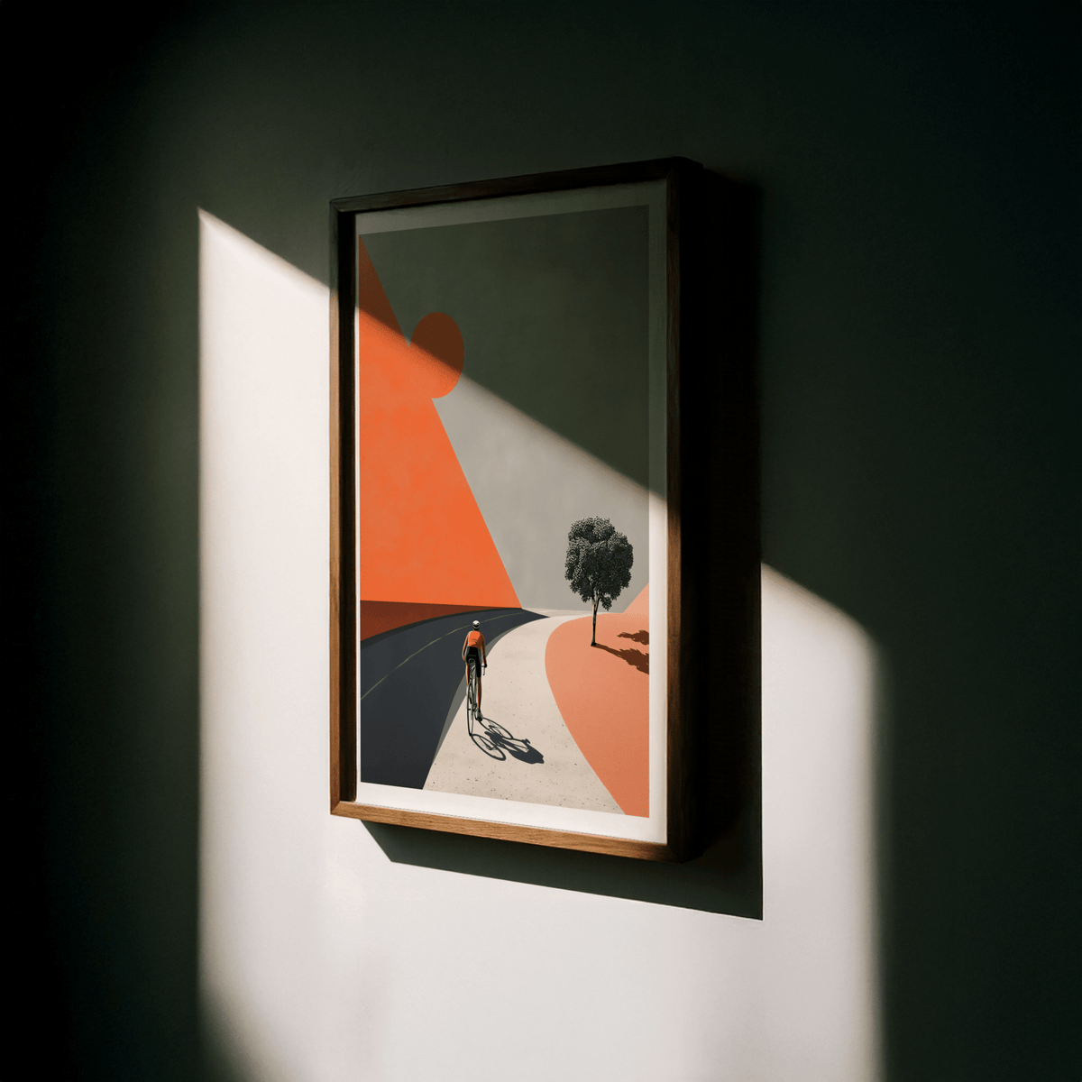 Framed close-up of cycling landscape art print featuring a cyclist on a curved road in orange and grey tones
