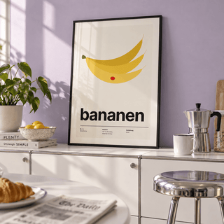 Yellow bananas with red sticker print in a breakfast kitchen against a lavender wall