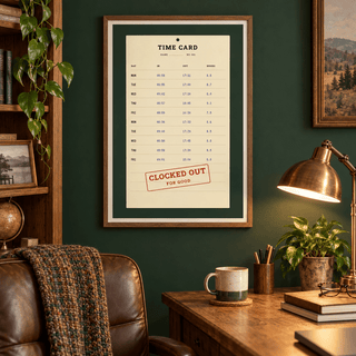 Vintage time card retirement print above a desk in a quiet home study