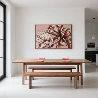 Pink Background Flower Print hanging above a wooden dining table with benches in a bright dining room