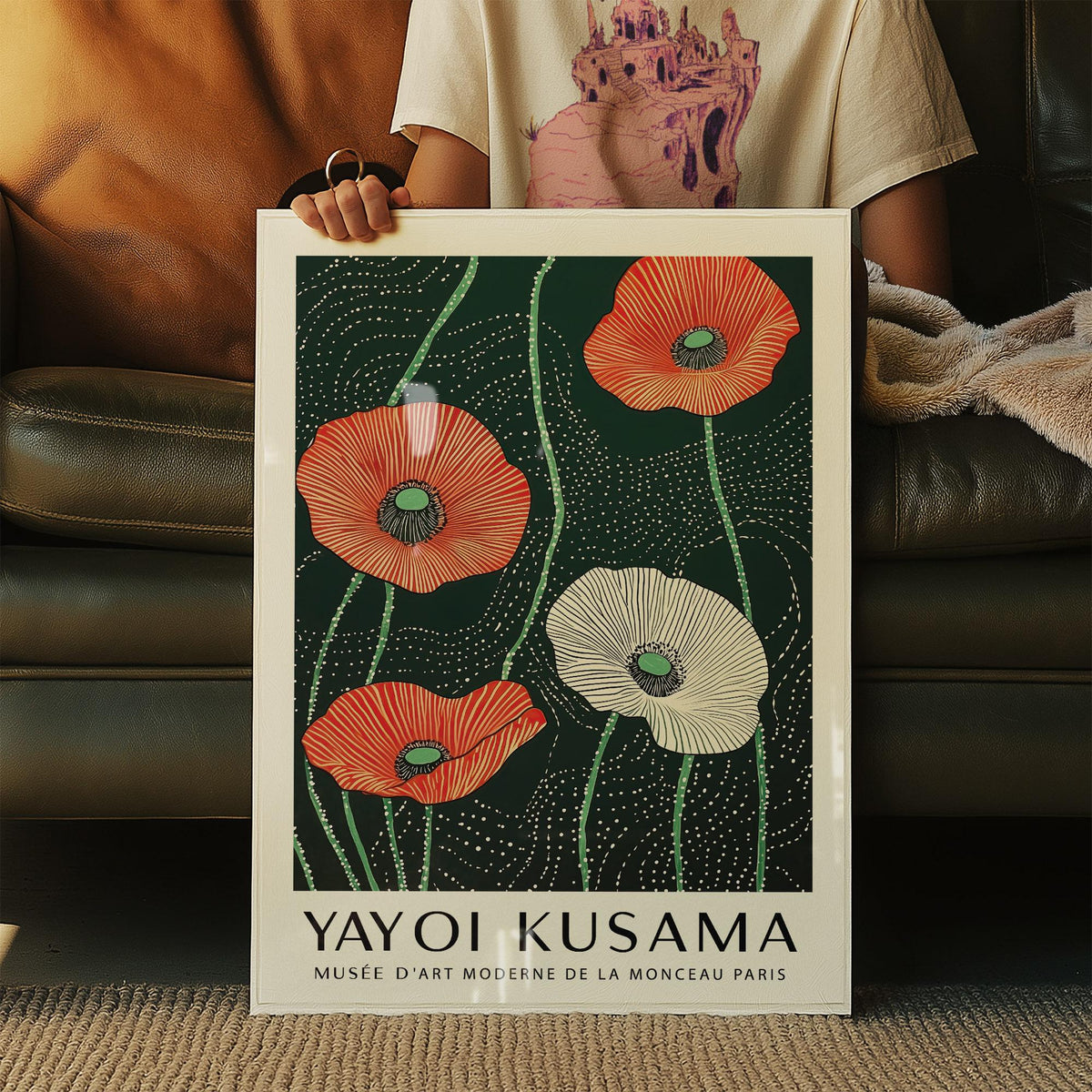 Framed Extra Large Floral Wall Art with red and white minimalist poppies held sitting on a sofa