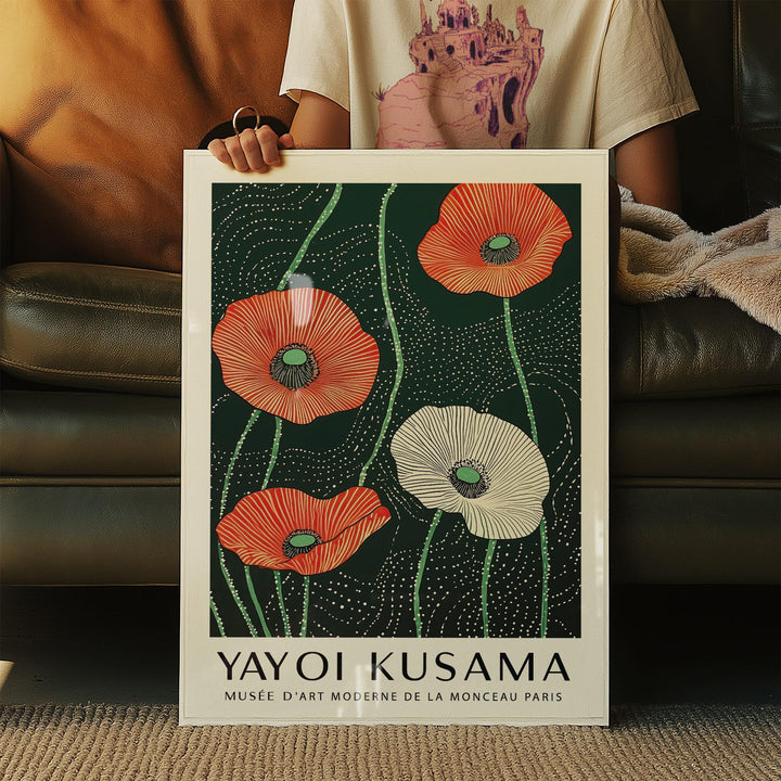 Framed Extra Large Floral Wall Art with red and white minimalist poppies held sitting on a sofa