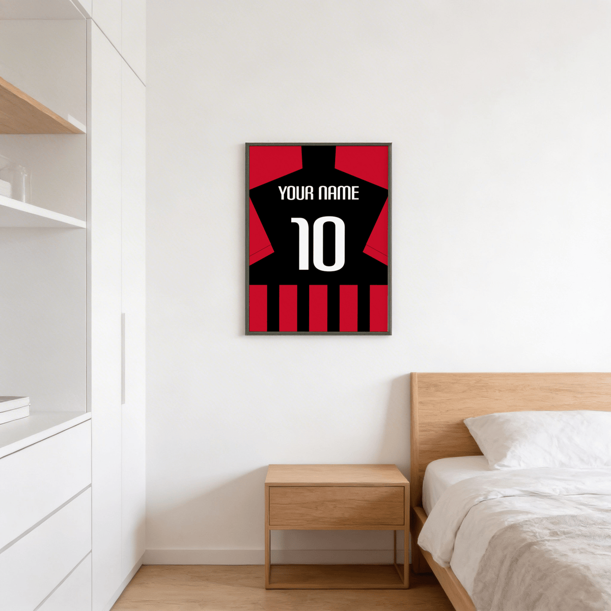 Framed Football Shirt Poster in Black and Red Stripes above a wooden bedside cabinet in a bedroom