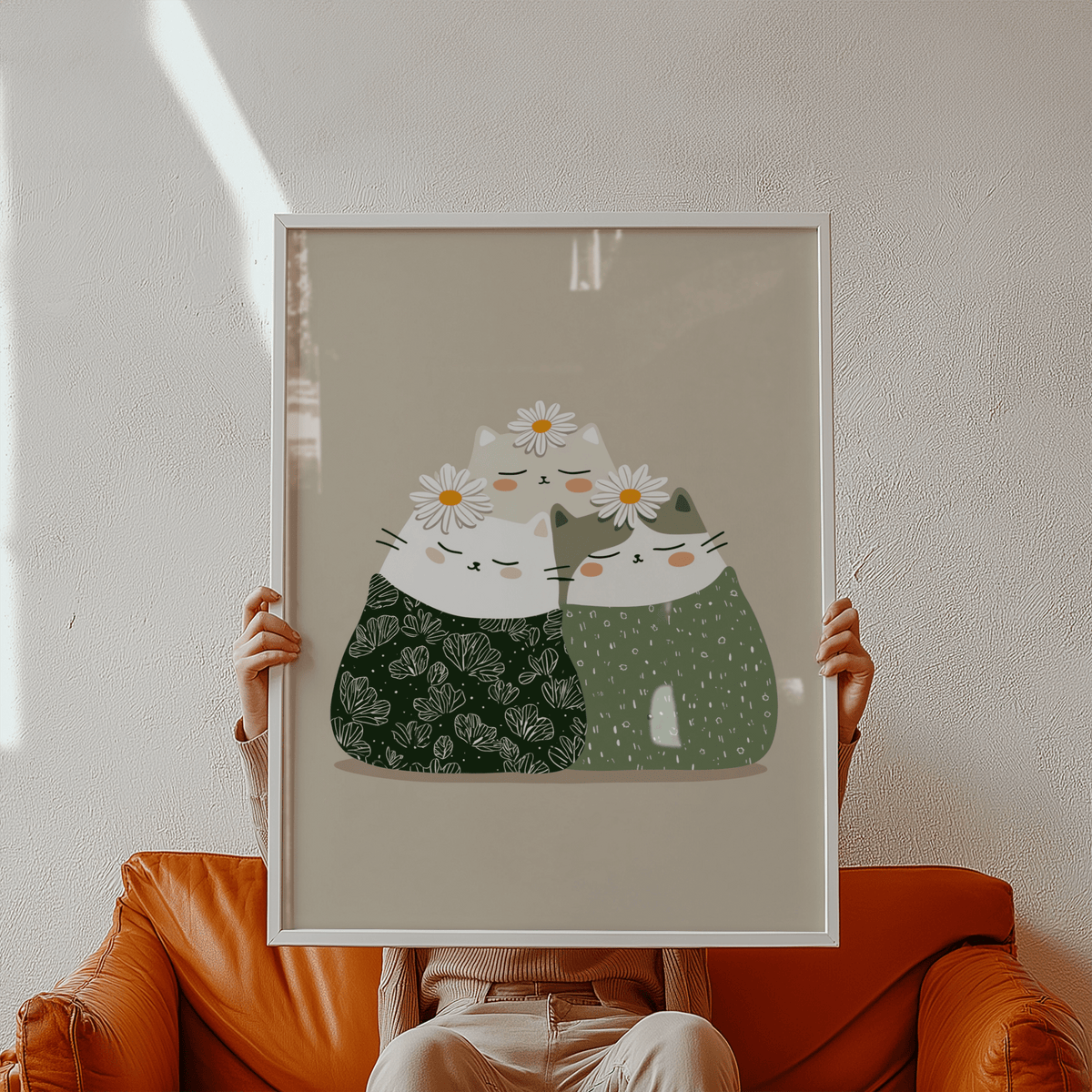 Framed Illustrated Cat Wall Art of three minimalist cats with daisies held above a brown sofa