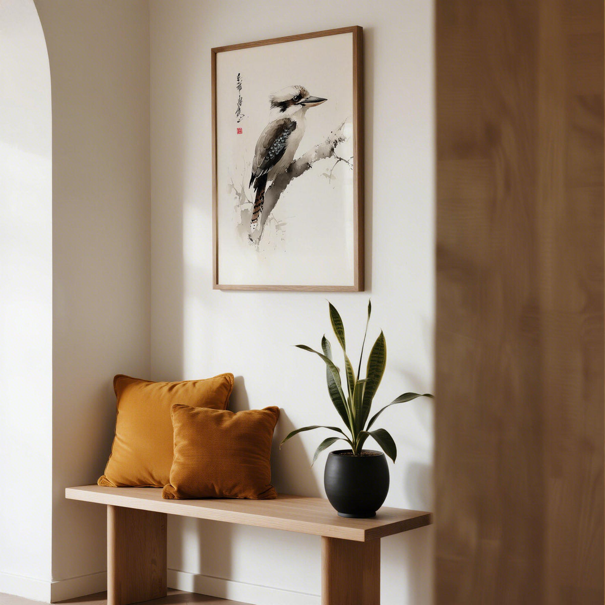 Print on a wall in a hallway showing Japanese bird art of a kookaburra perched on a branch with warm cushions nearby