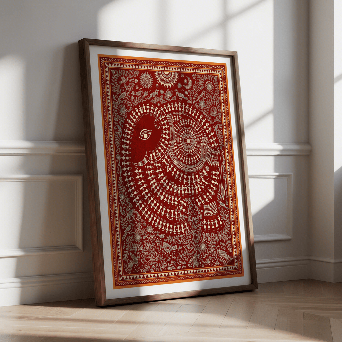Indian Folk Art Poster leaning against a wall with sunlight showcasing a decorative red and cream elephant print