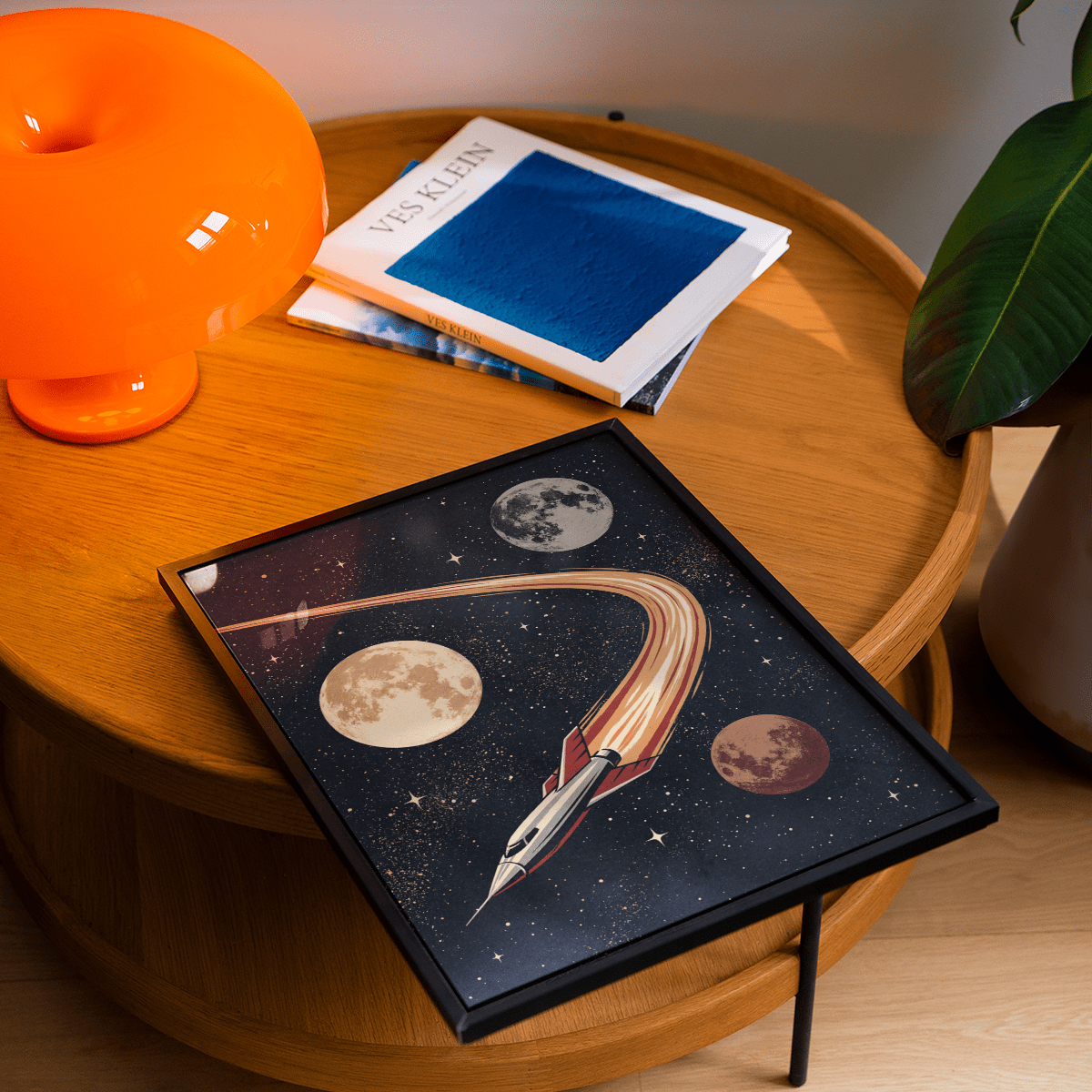 Framed print close-up of a retro rocket ship with planets on a wooden table with an orange lamp