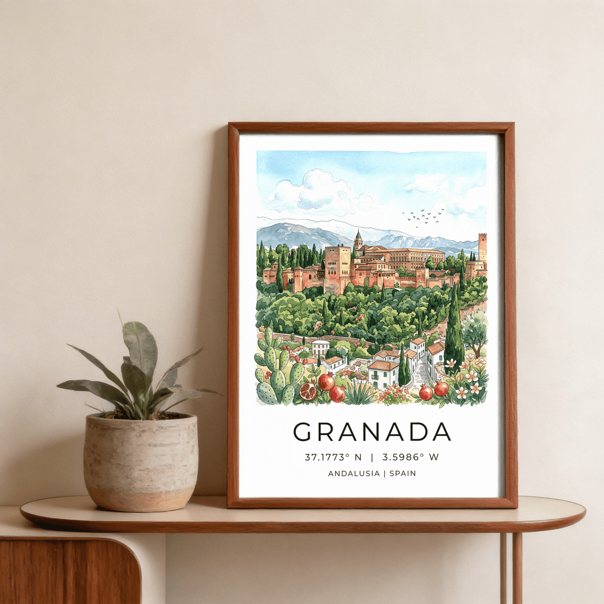 Framed Granada Spain art print of Alhambra fortress in watercolour style on console table with plant