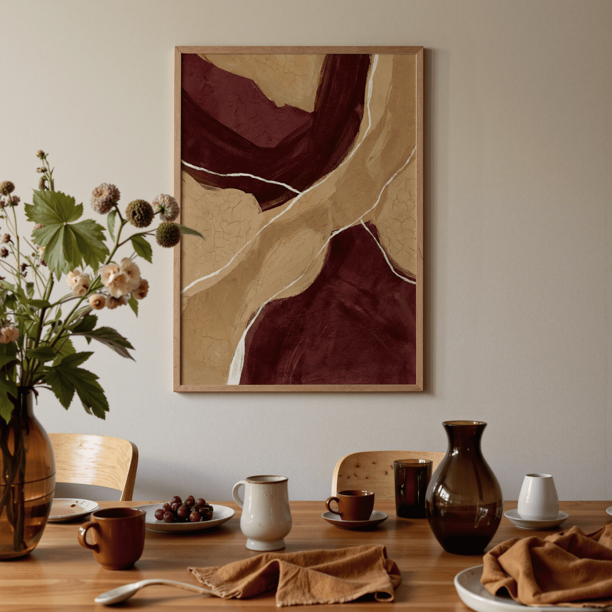 Neutral Organic Abstract Art framed print with maroon and beige shapes above a dining table with crockery