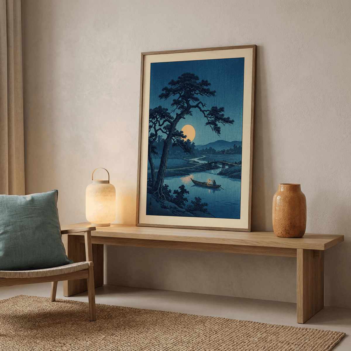 Moonlight Print framed print leaning on a wooden bench with a lamp and a vase nearby