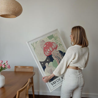 Framed Unique Large Wall Art of pink jellyfish with green and navy line-art held by a woman