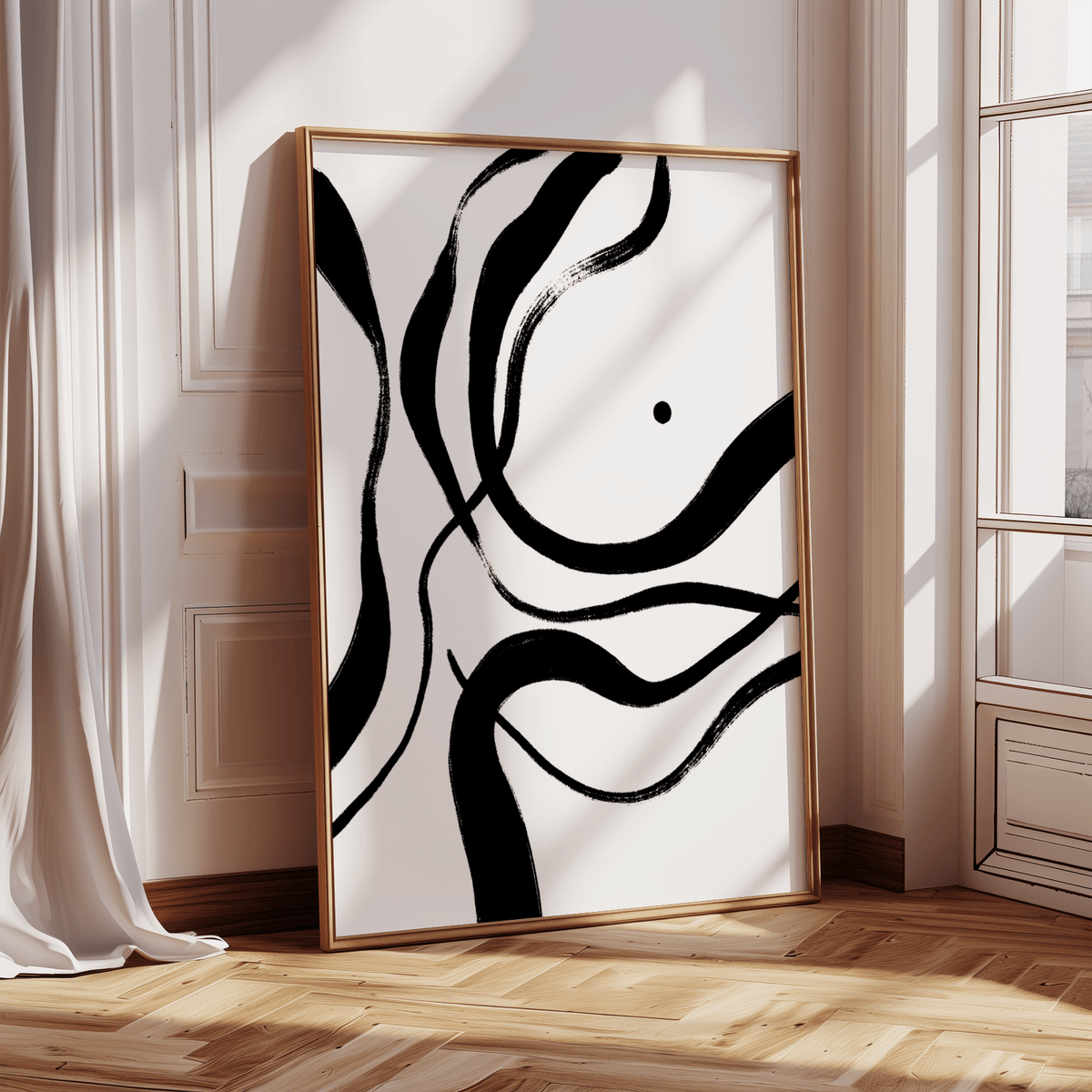 Print leaning on floor of black and white art with abstract brush strokes in natural light