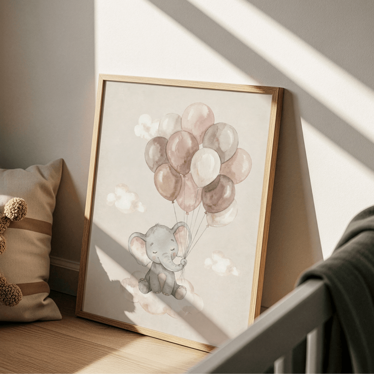 Print leaning on a floor with a pillow nearby baby elephant with balloons in soft watercolour tones