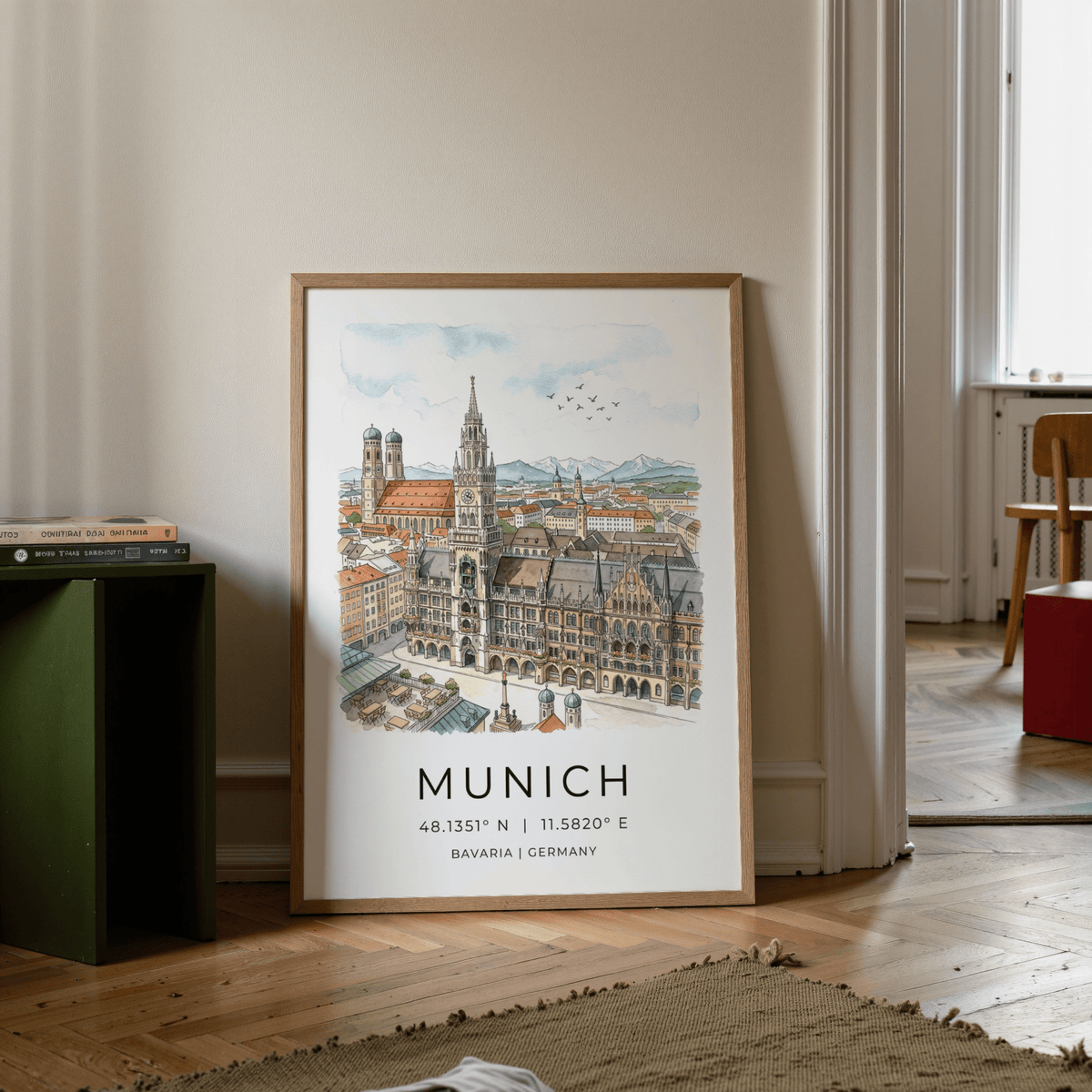 Munich City wall art leaning on floor with illustration of the city skyline and soft watercolours near a book pile