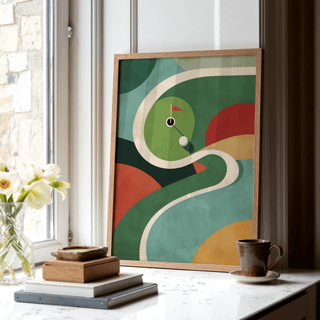 Geometric Golf Art Print leaning on a white windowsill with books and a cup nearby showing abstract green and red shapes
