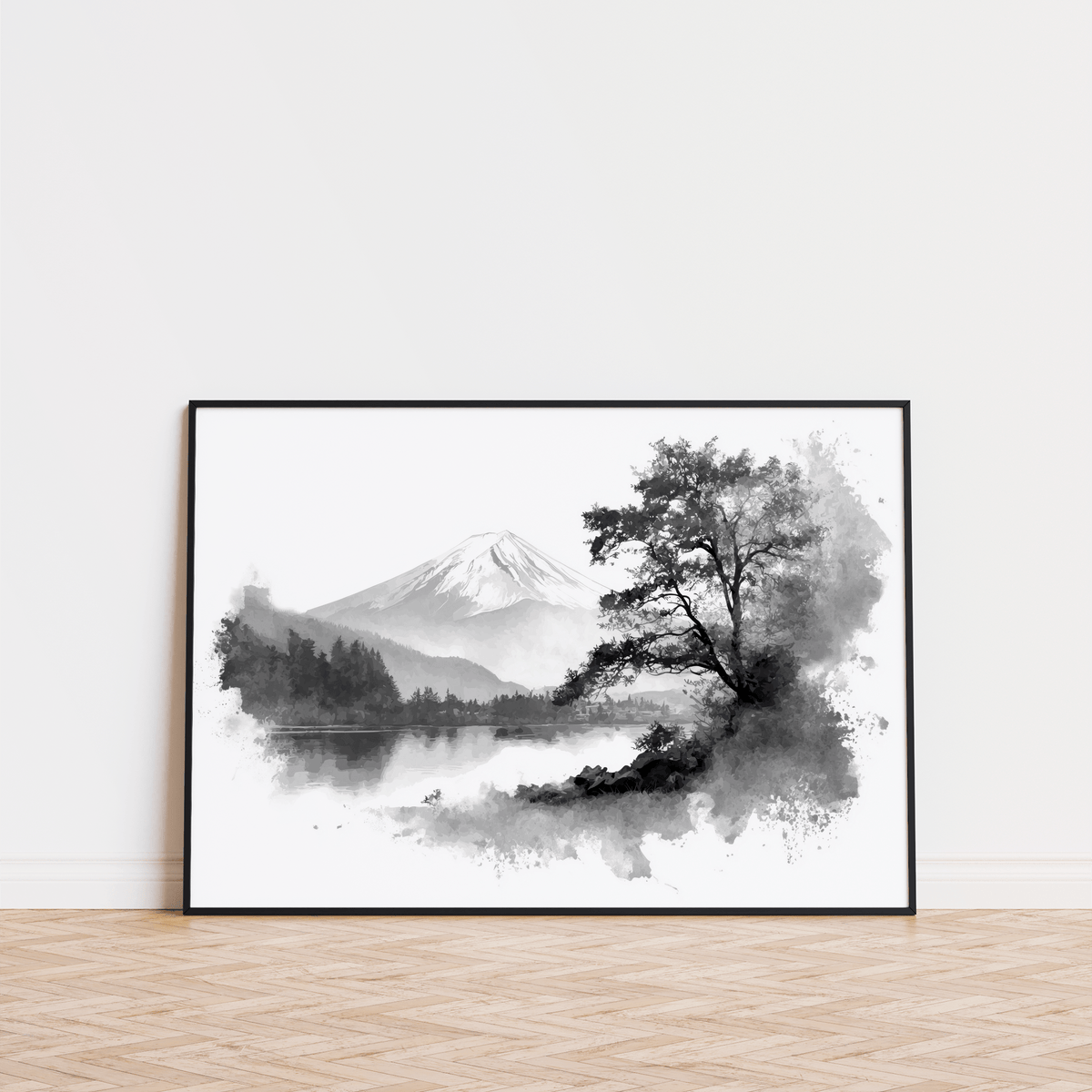 Black And White Print leaning on a wooden floor showing a mountain lake in watercolour style with black and grey tones